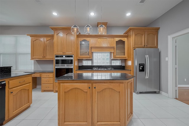 6210 Mahogany Way, Magnolia, TX 77354 - kitchen with appliances with stainless steel finishes, a center island, light tile patterned floors, glass insert cabinets, and recessed lighting