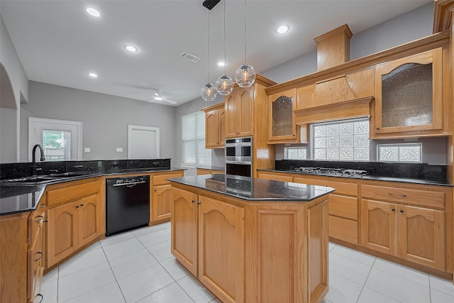 6210 Mahogany Way, Magnolia, TX 77354 - kitchen featuring appliances with stainless steel finishes, a kitchen island, light tile patterned floors, a ceiling fan, and decorative light fixtures