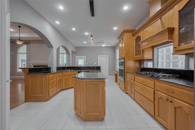 6210 Mahogany Way, Magnolia, TX 77354 - kitchen with ceiling fan, a center island, gas stovetop, arched walkways, and recessed lighting