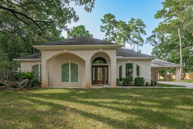 6210 Mahogany Way, Magnolia, TX 77354 - mediterranean / spanish house featuring a carport, brick siding, roof with shingles, and a front lawn