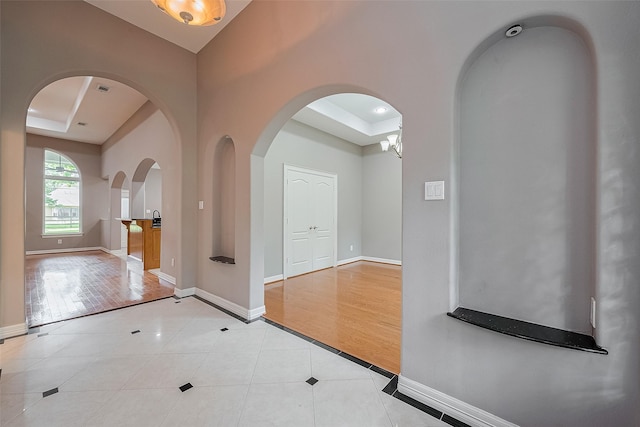 6210 Mahogany Way, Magnolia, TX 77354 - entryway with a tray ceiling, light tile patterned flooring, and inlaid floor details