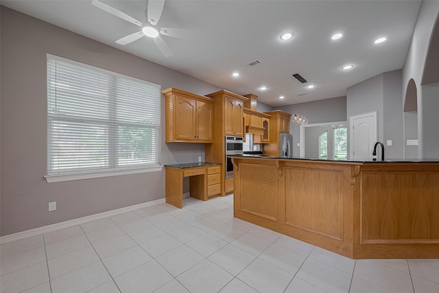6210 Mahogany Way, Magnolia, TX 77354 - kitchen with appliances with stainless steel finishes, dark countertops, a ceiling fan, a kitchen bar, and pendant lighting