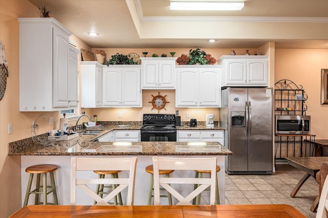 989 Biscayne, Crystal Beach, TX 77650 - kitchen featuring appliances with stainless steel finishes, a peninsula, a breakfast bar, white cabinetry, and crown molding