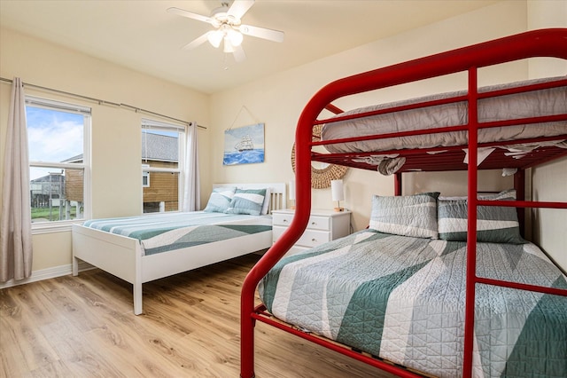 989 Biscayne, Crystal Beach, TX 77650 - bedroom featuring wood finished floors, multiple windows, and a ceiling fan