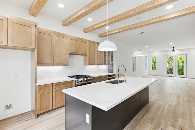 2221 Bevis St, Houston, TX 77008 - kitchen featuring stainless steel range with gas cooktop, decorative backsplash, light wood-type flooring, beam ceiling, and light stone counters