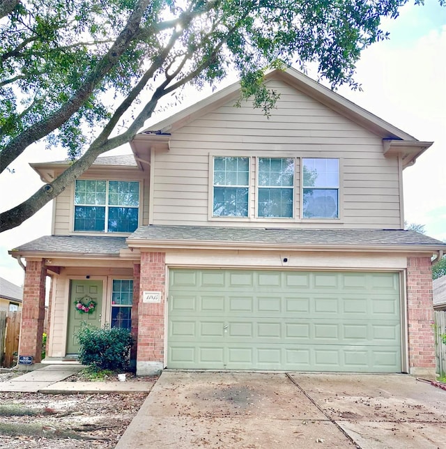 11815 Pebble Sands Dr, Tomball, TX 77375 - traditional home featuring a garage, brick siding, concrete driveway, and a shingled roof