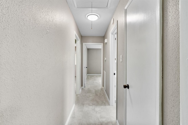 21807 Glenbranch Dr, Spring, TX 77388 - hallway featuring attic access, light tile patterned flooring, and a textured wall