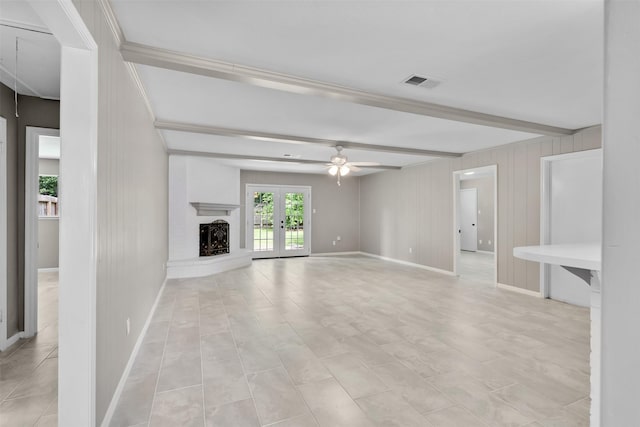 21807 Glenbranch Dr, Spring, TX 77388 - unfurnished living room with beam ceiling, ceiling fan, a fireplace with raised hearth, and french doors