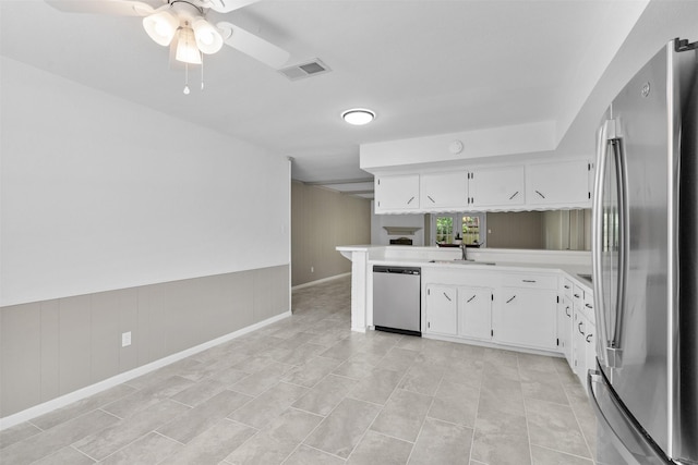 21807 Glenbranch Dr, Spring, TX 77388 - kitchen with stainless steel appliances, a peninsula, white cabinets, light countertops, and ceiling fan