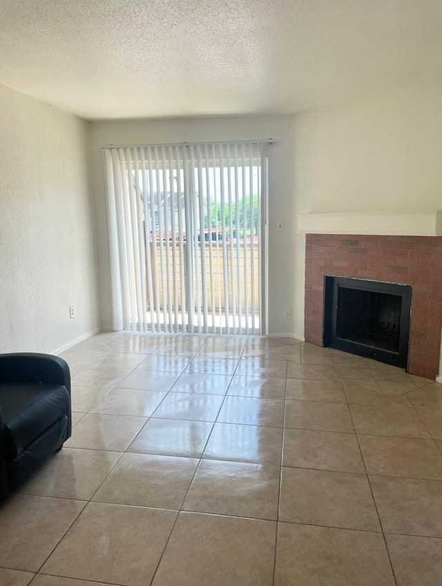 8405 Wilcrest Dr Unit 1606, Houston, TX 77072 - tiled living room featuring a fireplace and a textured ceiling