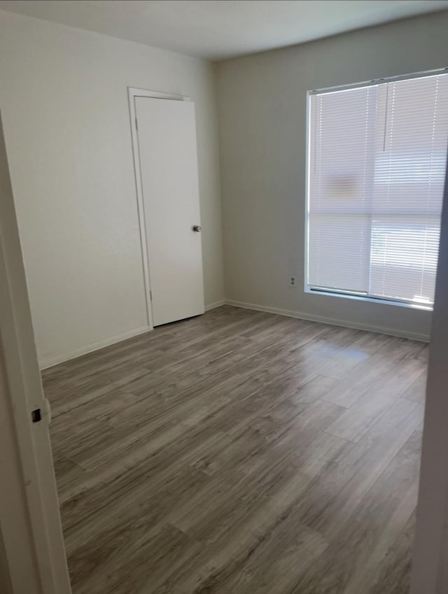 8405 Wilcrest Dr Unit 1606, Houston, TX 77072 - unfurnished room featuring dark wood-style flooring and baseboards