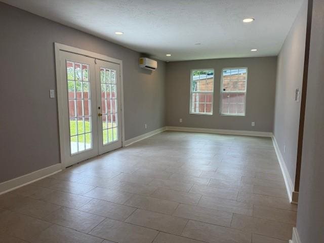 3210 Oakmont St, Houston, TX 77021 - empty room with healthy amount of natural light, french doors, a wall mounted air conditioner, and recessed lighting