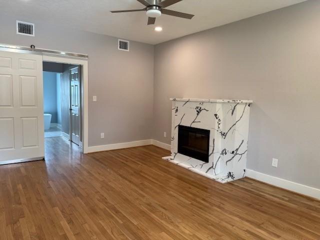 3210 Oakmont St, Houston, TX 77021 - unfurnished living room featuring ceiling fan, a premium fireplace, wood finished floors, and recessed lighting