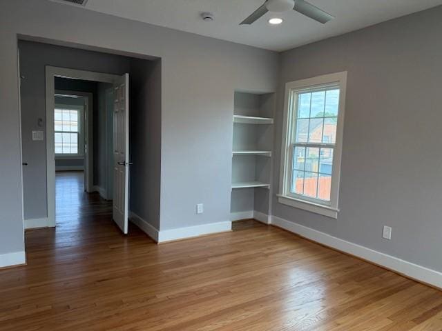 3210 Oakmont St, Houston, TX 77021 - spare room featuring built in features, healthy amount of natural light, and wood finished floors