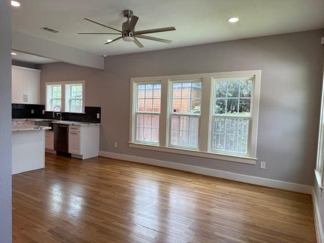 3210 Oakmont St, Houston, TX 77021 - kitchen with dishwasher, white cabinetry, wood finished floors, a ceiling fan, and light countertops