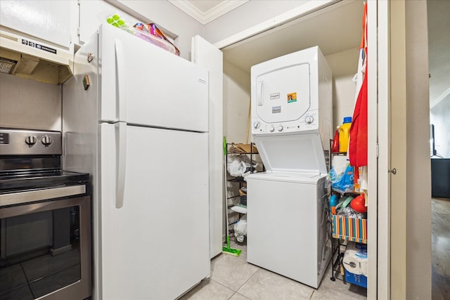 2333 Bering Dr Unit 236, Houston, TX 77057 - washroom with stacked washing machine and dryer, light tile patterned floors, and ornamental molding