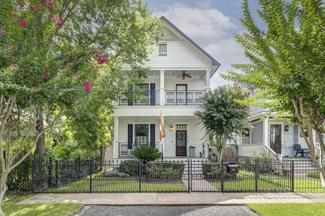 818 Waverly St, Houston, TX 77007 - greek revival house with covered porch, a balcony, ceiling fan, and a fenced front yard