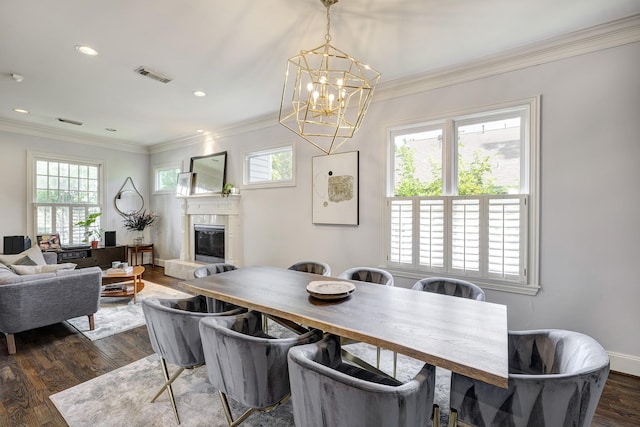 818 Waverly St, Houston, TX 77007 - dining space with a chandelier, plenty of natural light, a premium fireplace, ornamental molding, and dark wood-style floors