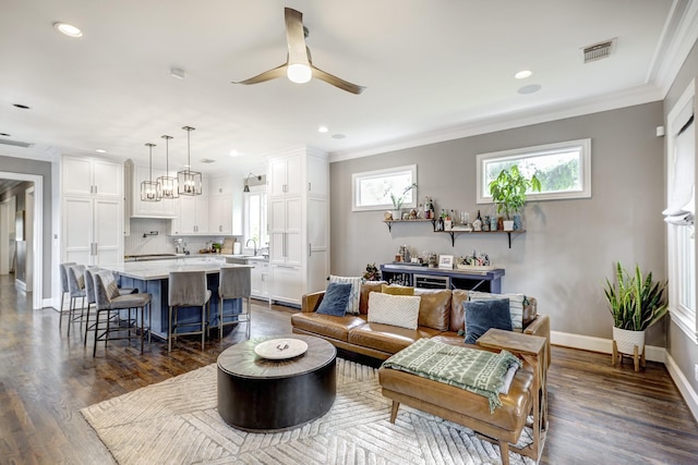 818 Waverly St, Houston, TX 77007 - living area featuring crown molding, ceiling fan, dark wood-type flooring, recessed lighting, and a chandelier