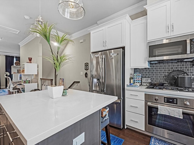 9660 Knight Rd, Houston, TX 77045 - kitchen with stainless steel appliances, crown molding, dark wood-type flooring, light countertops, and backsplash
