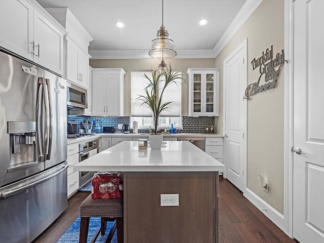 9660 Knight Rd, Houston, TX 77045 - kitchen with stainless steel appliances, ornamental molding, light countertops, tasteful backsplash, and dark wood-type flooring