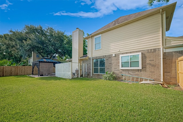 4001 Spring Garden Dr, Pearland, TX 77584 - back of house featuring brick siding, a gazebo, a chimney, and a fenced backyard