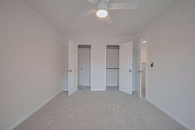 4001 Spring Garden Dr, Pearland, TX 77584 - unfurnished bedroom with two closets, light carpet, and a ceiling fan