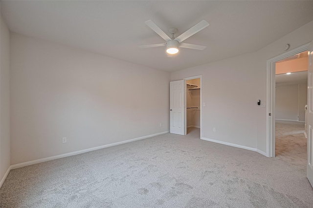 4001 Spring Garden Dr, Pearland, TX 77584 - unfurnished bedroom featuring light colored carpet, a spacious closet, and a ceiling fan
