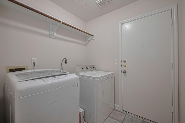 4001 Spring Garden Dr, Pearland, TX 77584 - laundry room with washing machine and dryer and light tile patterned flooring