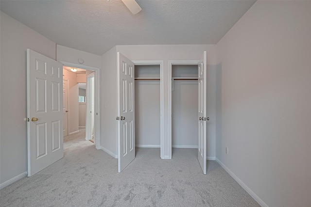 4001 Spring Garden Dr, Pearland, TX 77584 - unfurnished bedroom with carpet floors, two closets, a ceiling fan, and a textured ceiling
