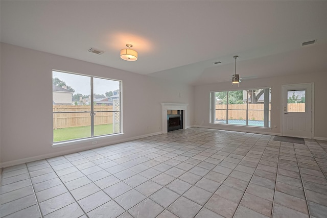 4001 Spring Garden Dr, Pearland, TX 77584 - unfurnished living room with light tile patterned floors, a fireplace, and ceiling fan