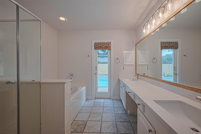 4001 Spring Garden Dr, Pearland, TX 77584 - full bathroom featuring double vanity, healthy amount of natural light, a bath, a shower with door, and recessed lighting