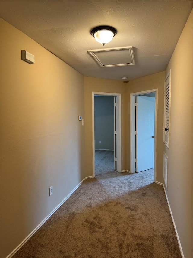 15718 Colonial Bridge Ln, Houston, TX 77073 - corridor with attic access, carpet flooring, and a textured ceiling