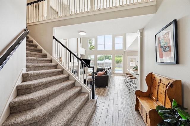 5602 Bergenfield Ct, Katy, TX 77450 - stairs featuring a towering ceiling and wood finished floors
