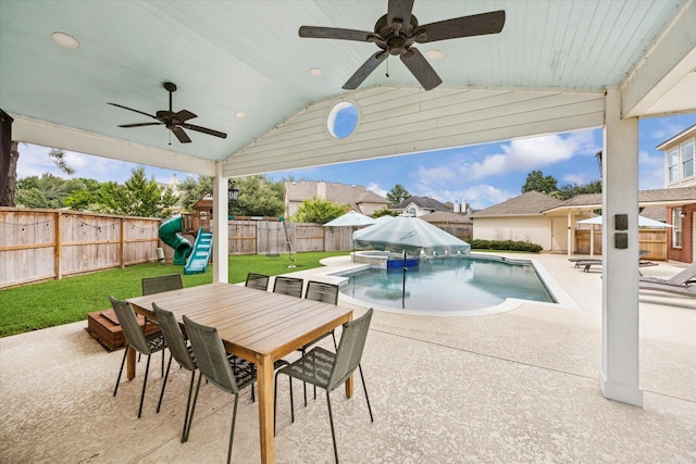 5602 Bergenfield Ct, Katy, TX 77450 - view of swimming pool featuring a fenced backyard, a patio area, a playground, a ceiling fan, and outdoor dining space