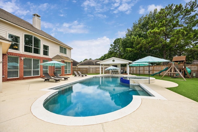 5602 Bergenfield Ct, Katy, TX 77450 - view of swimming pool with a patio, a fenced backyard, a pool with connected hot tub, a playground, and a gazebo