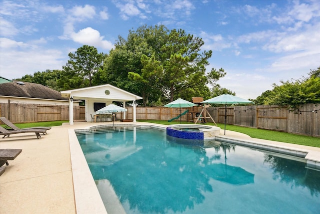 5602 Bergenfield Ct, Katy, TX 77450 - view of pool featuring a playground, a patio area, a fenced backyard, and a pool with connected hot tub