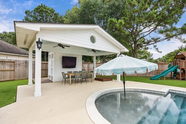 5602 Bergenfield Ct, Katy, TX 77450 - view of swimming pool featuring ceiling fan, a playground, a fenced backyard, a patio area, and outdoor dining space