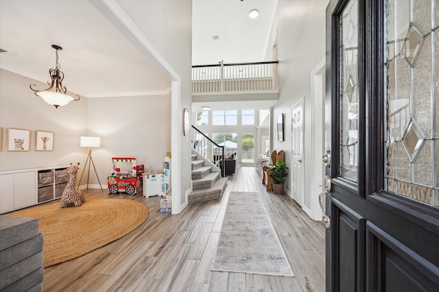 5602 Bergenfield Ct, Katy, TX 77450 - entrance foyer with stairway, light wood finished floors, ornamental molding, and a high ceiling