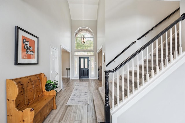 5602 Bergenfield Ct, Katy, TX 77450 - entrance foyer featuring a high ceiling, stairway, light wood-type flooring, and crown molding