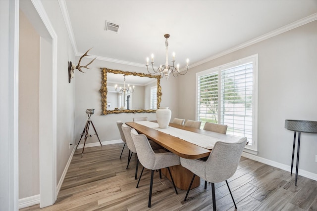 5602 Bergenfield Ct, Katy, TX 77450 - dining room with a chandelier, light wood finished floors, and ornamental molding