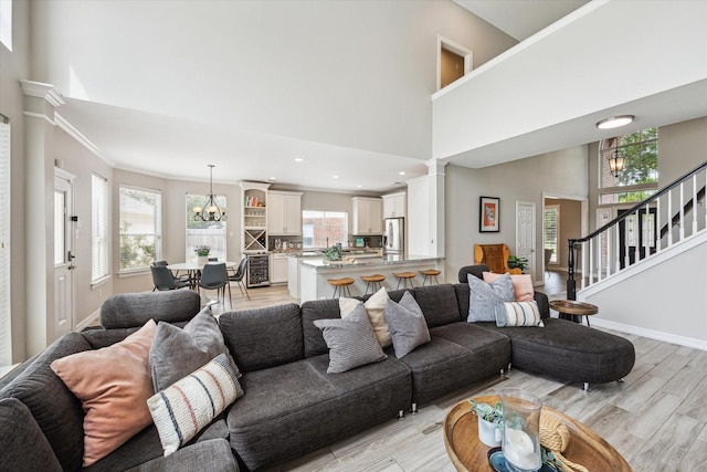 5602 Bergenfield Ct, Katy, TX 77450 - living area with light wood-type flooring, healthy amount of natural light, a chandelier, crown molding, and recessed lighting