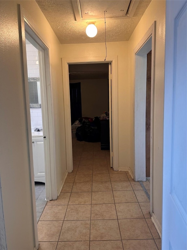 2122 Kowis St, Houston, TX 77093 - corridor featuring light tile patterned floors and a textured ceiling