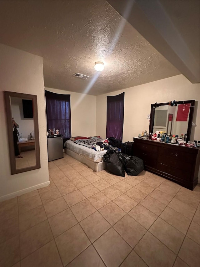 2122 Kowis St, Houston, TX 77093 - bedroom with a textured ceiling and light tile patterned flooring
