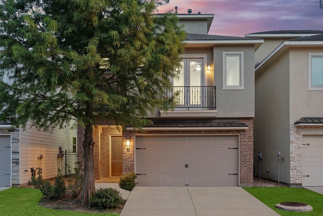 10 Jarvis Row Cir, The Woodlands, TX 77380 - view of front of property with concrete driveway, stucco siding, a garage, and a balcony