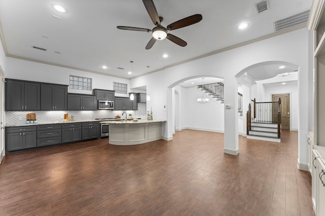 10 Jarvis Row Cir, The Woodlands, TX 77380 - kitchen with stainless steel appliances, ceiling fan, arched walkways, tasteful backsplash, and recessed lighting
