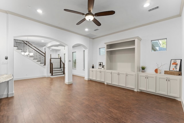 10 Jarvis Row Cir, The Woodlands, TX 77380 - unfurnished living room with ceiling fan, stairway, dark wood-style flooring, arched walkways, and ornamental molding