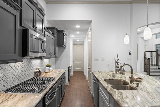10 Jarvis Row Cir, The Woodlands, TX 77380 - kitchen featuring appliances with stainless steel finishes, dark wood finished floors, light stone countertops, tasteful backsplash, and pendant lighting