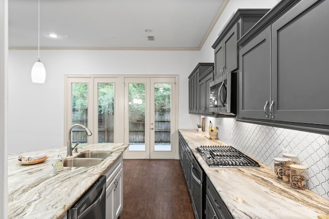 10 Jarvis Row Cir, The Woodlands, TX 77380 - kitchen with appliances with stainless steel finishes, tasteful backsplash, dark wood-type flooring, crown molding, and light stone counters