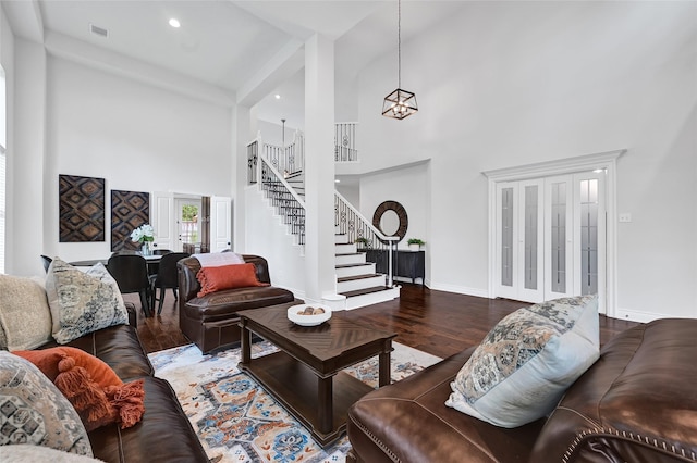 135 Wisteria Walk Cir, The Woodlands, TX 77381 - living room featuring a towering ceiling, stairway, wood finished floors, a chandelier, and recessed lighting